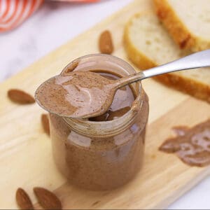 Almond Butter - Medium Roast in a jar with spoon - Smirk's Bulk Almond Butter Supplier